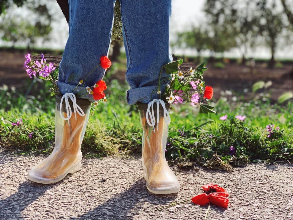 Better Food Trader with flowers in her wellington boots